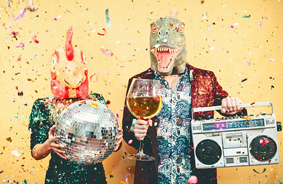 Crazy couple celebrating new year eve wearing chicken and dinosaur t-rex mask - Young trendy people having fun drinking champagne and listening music with vintage boombox - Absurd and holidays concept